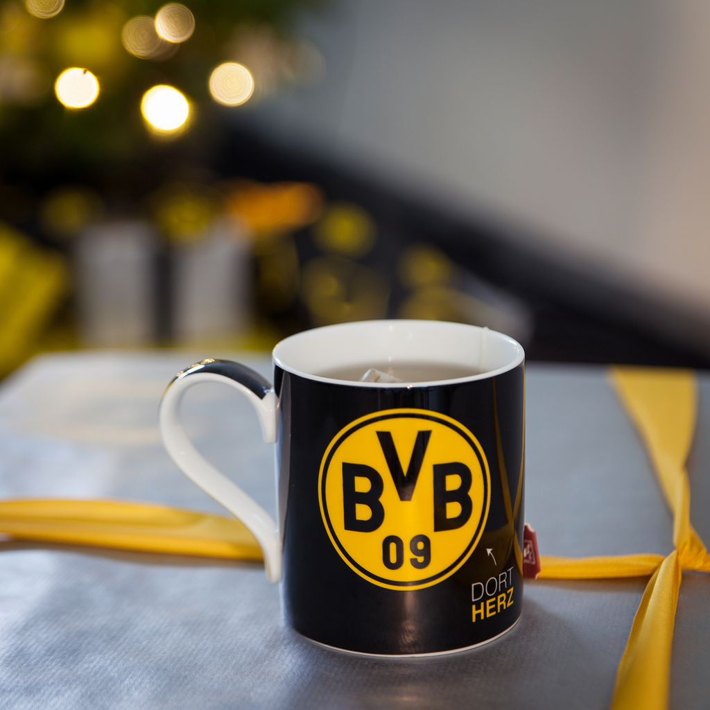 Black-and-yellow BVB mug with a large BVB logo and the words "Dort Herz," perfect for fans of the Borussia Dortmund soccer club.
