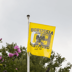 Black-and-yellow BVB flag featuring the city coat of arms and the words "Borussia Dortmund," measuring 150 x 100 cm, fluttering on a pole against a natural background.
