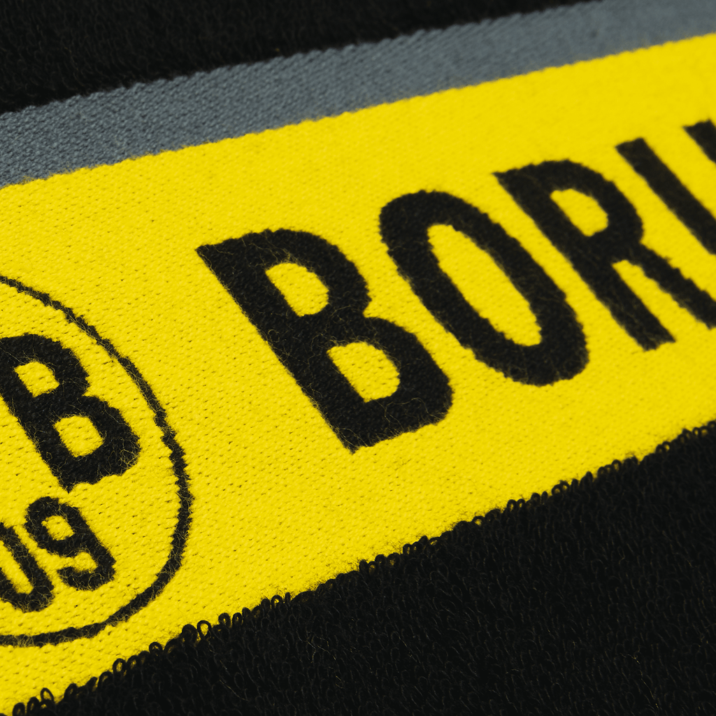 Asciugamano del BVB nei colori nero e giallo con lo stemma del Borussia Dortmund, ideale per i tifosi e perfetto come articolo di merchandising.