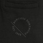 Vista dettagliata di un paio di pantaloni da ginnastica neri della squadra femminile del BVB con la scritta “Est. 1909” e il logo del Borussia Dortmund.