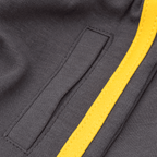 Close-up of a pair of BVB children's pants with a side pocket and black fabric, accented with a yellow stripe.
