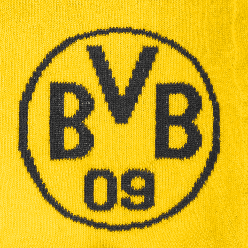 BVB 09のロゴが入った黄色のベビー用タイツのクローズアップ写真。ボルシア・ドルトムントの小さなファンにぴったりです。