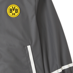 Veste de pluie BVB gris foncé pour bébés et jeunes enfants, ornée d'un emblème BVB 09 jaune bien visible et de bandes décoratives blanches.