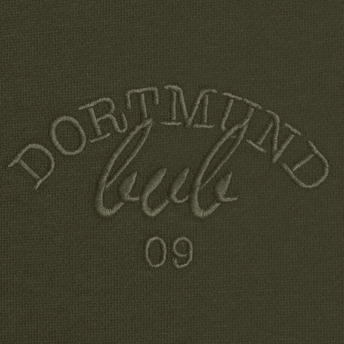 Primo piano della maglia a girocollo da donna del BVB, di colore verde scuro, con la scritta “Dortmund” ricamata e il numero 09.