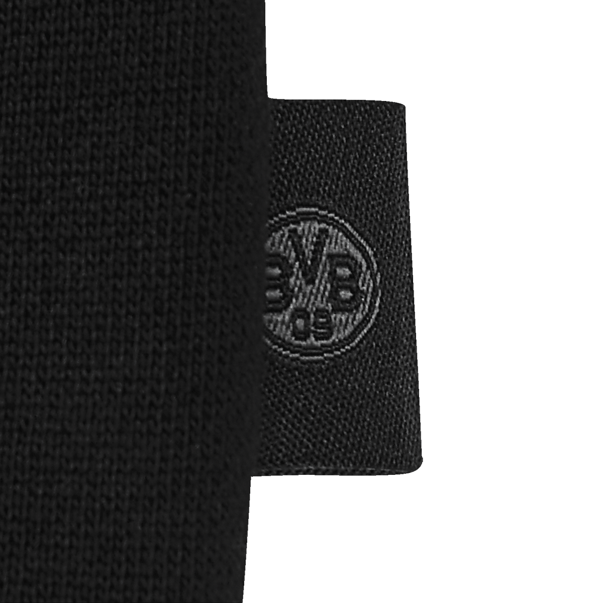 Close-up of the black label on a BVB sweater featuring a woven-in BVB logo.
