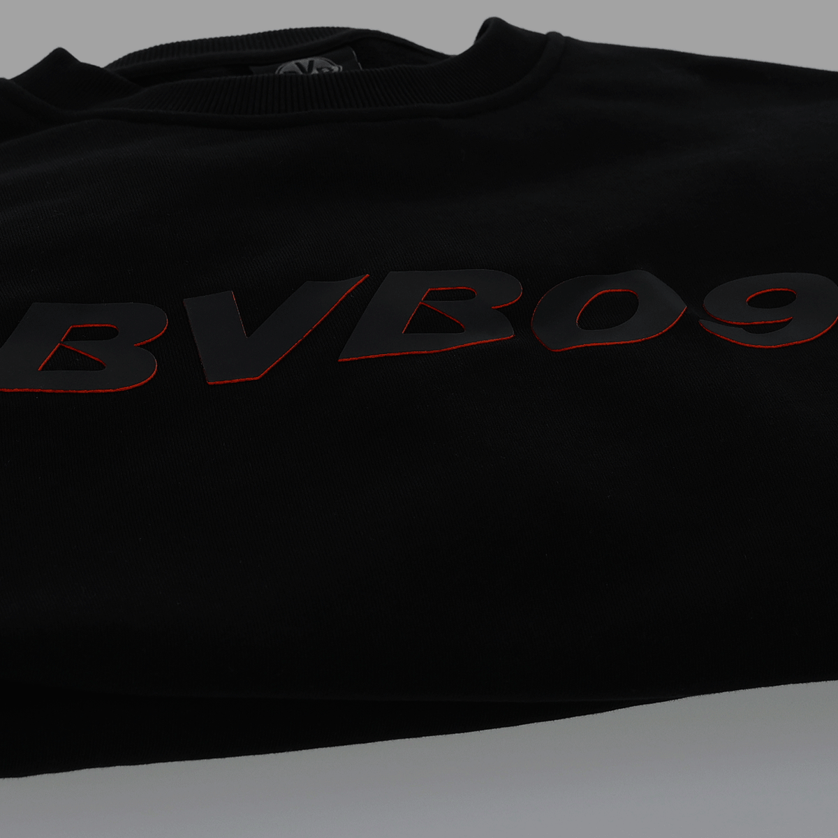 Black BVB 09 sweater with large red lettering on the front, perfect for Borussia Dortmund fans.