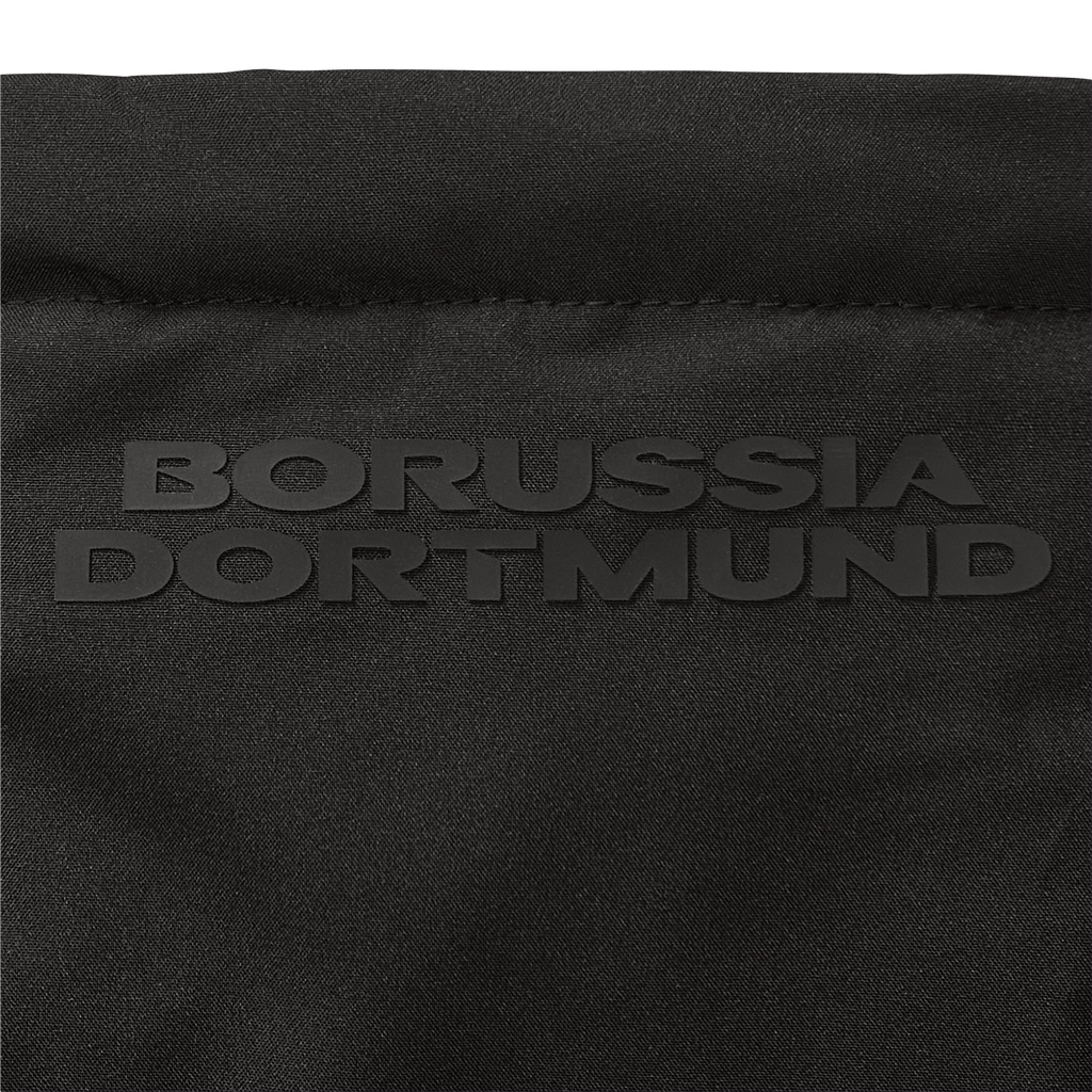 Close-up of a black BVB parka with embossed "Borussia Dortmund" lettering; high-quality fan merchandise design.