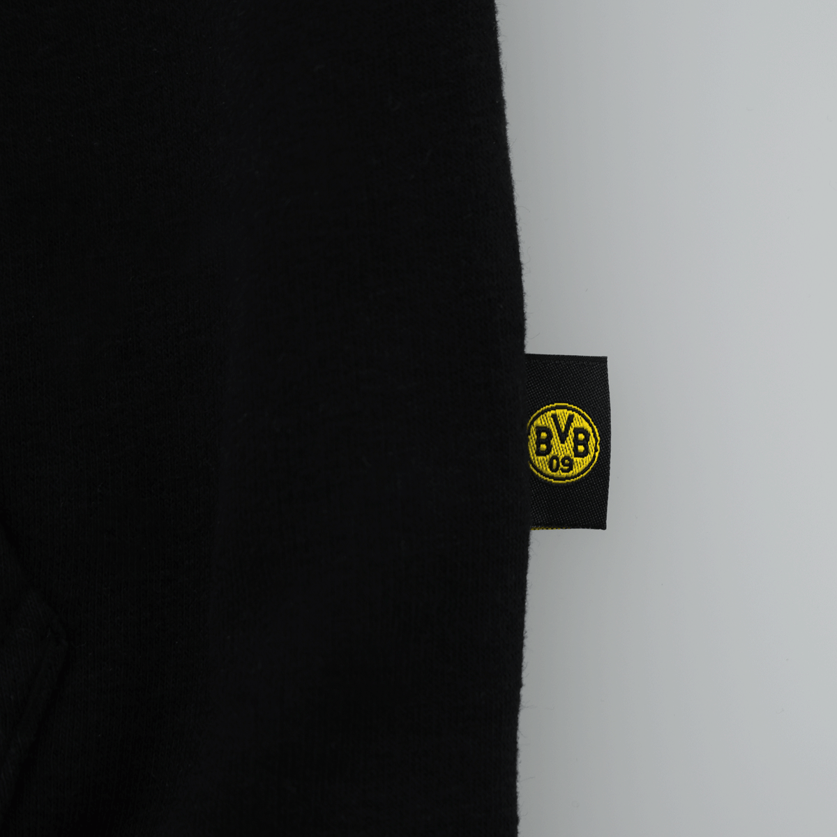 Vista dettagliata della giacca in felpa BVB Explorer, realizzata in tessuto nero con il logo BVB giallo sull'etichetta.