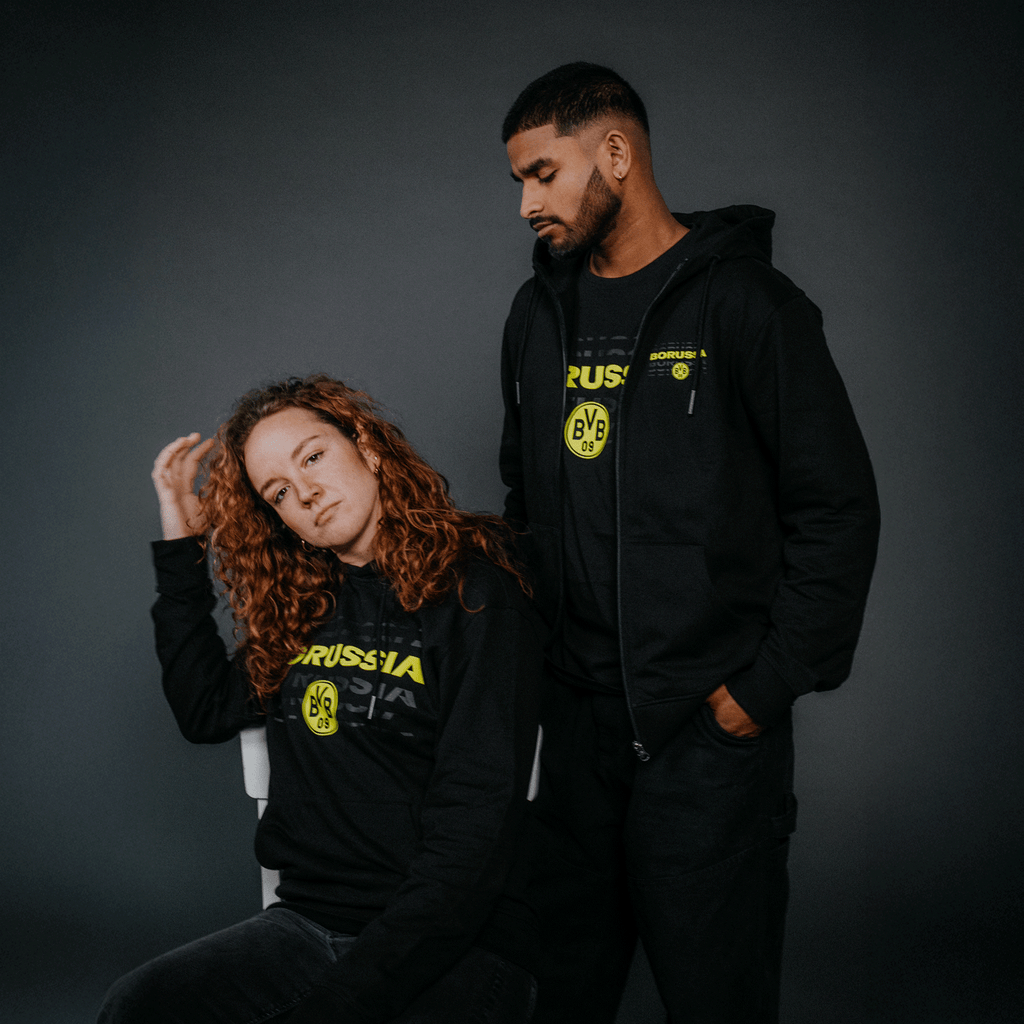 ネオンカラーのBVBエンブレムとロゴが入ったユニセックスの黒のBVBスウェットジャケット。ボルシア・ドルトムントのファンに最適です。