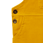 Close-up of yellow BVB corduroy pants for babies and toddlers, featuring buttons and a pocket—perfect for Borussia Dortmund fans.