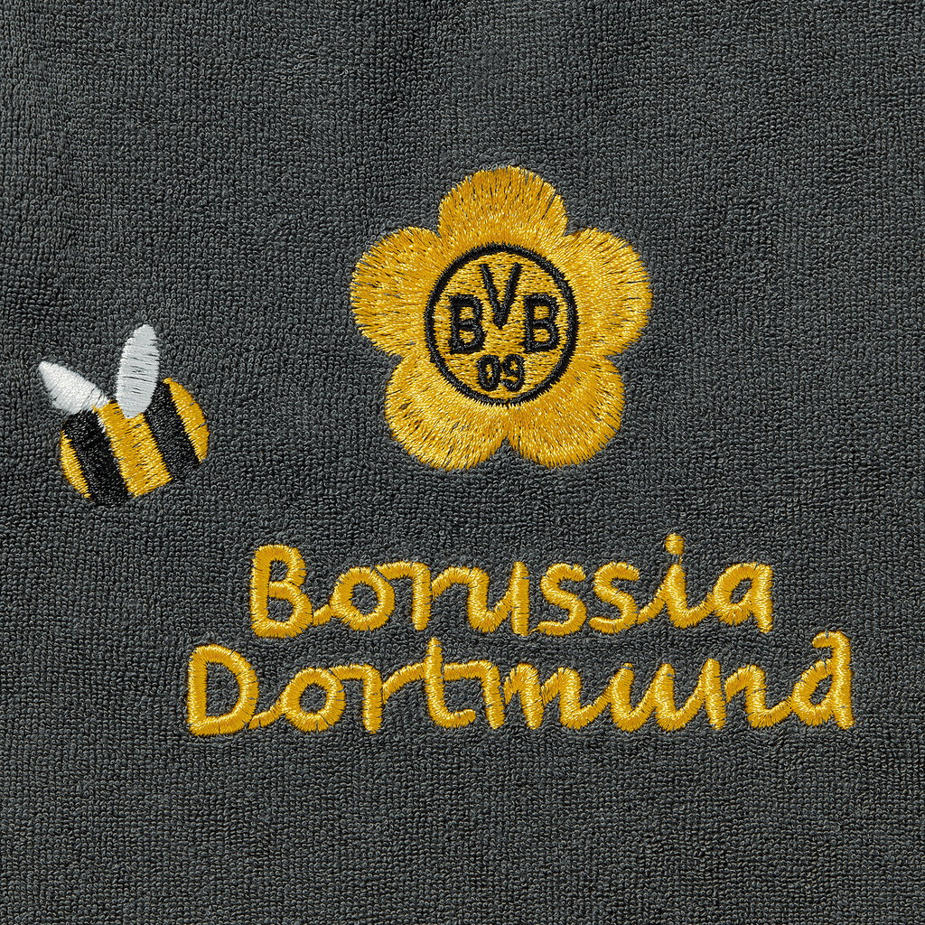 Bavaglino nero del BVB con il logo del Borussia Dortmund ricamato, un fiore giallo e un'ape nera e gialla come elementi decorativi.