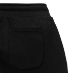 Vista dettagliata di un paio di pantaloni della tuta neri del BVB per bambini con tasca posteriore a vista, ideali per i tifosi del Borussia Dortmund.