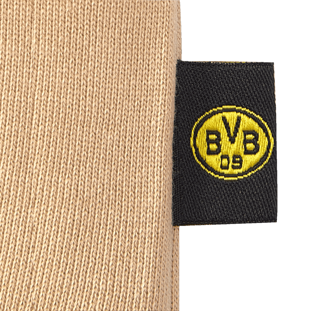 Pantaloni da bambino del BVB color beige con logo BVB 09 nero e giallo integrato su un'etichetta: un articolo perfetto per i giovani tifosi del Borussia Dortmund.