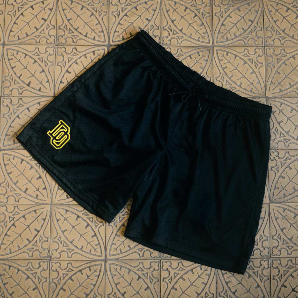 Pantaloncini da allenamento BVB College nei colori nero e giallo con logo BVB stampato, ideali per i tifosi del Borussia Dortmund.