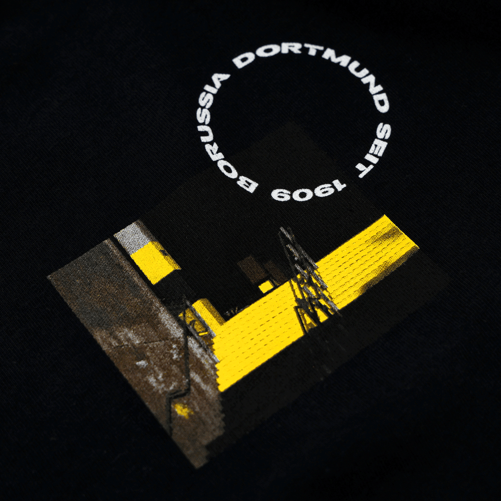 Close-up of the BVB Matchday II zip jacket featuring a black-and-yellow design and the words "Borussia Dortmund since 1909."