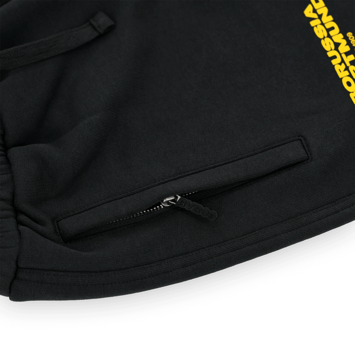 Black BVB urban sweatpants with yellow Borussia Dortmund lettering and practical zippers, ideal for sports and leisure.