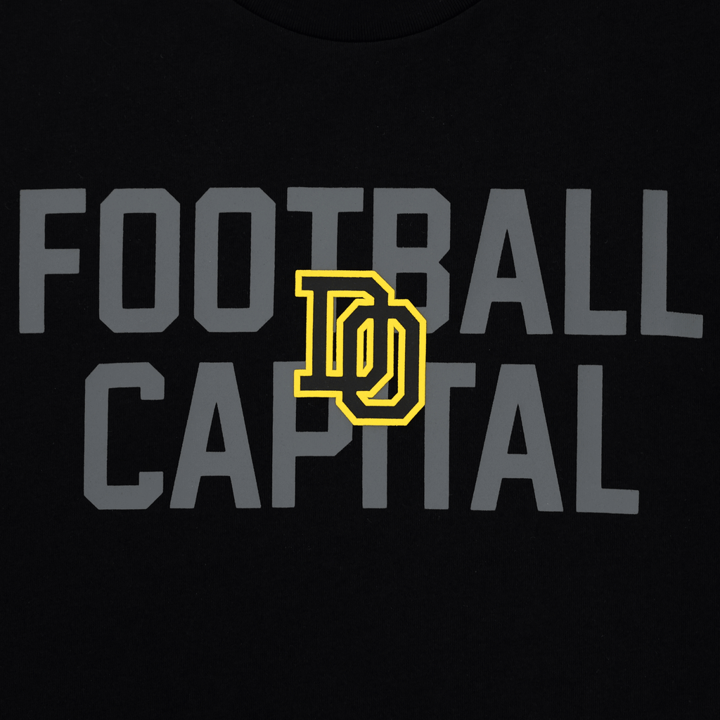 Schwarzes BVB College T-Shirt für Kinder mit grauem 'Football Capital'-Schriftzug und auffälligem gelbem Dortmund-Logo.
