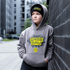 Gray BVB gaming hoodie for kids with a "Game Day" print in a pixelated style and the BVB logo, worn by a child leaning against a wall