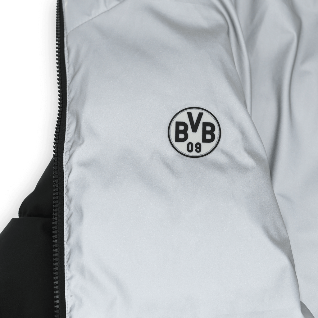 Veste réversible réfléchissante du BVB, avec un côté noir et un côté gris, ainsi qu’un logo BVB bien visible.