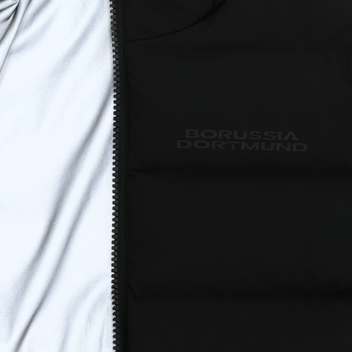Black BVB reversible jacket for kids with reflective material and the Borussia Dortmund logo—perfect for fans.