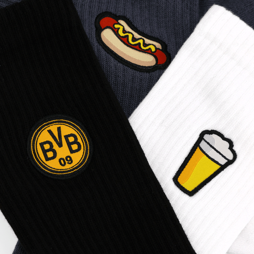 Calcetines BVB Festival II Icons en un pack de 3 con diseños exclusivos: el logotipo del BVB en negro y amarillo, y símbolos de perritos calientes y cerveza. Perfectos como artículos para aficionados.