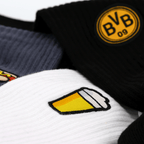 Lote de 3 pares de calcetines «BVB Festival Icons» en negro, gris y blanco, con el logotipo del BVB y motivos de cerveza y perritos calientes.