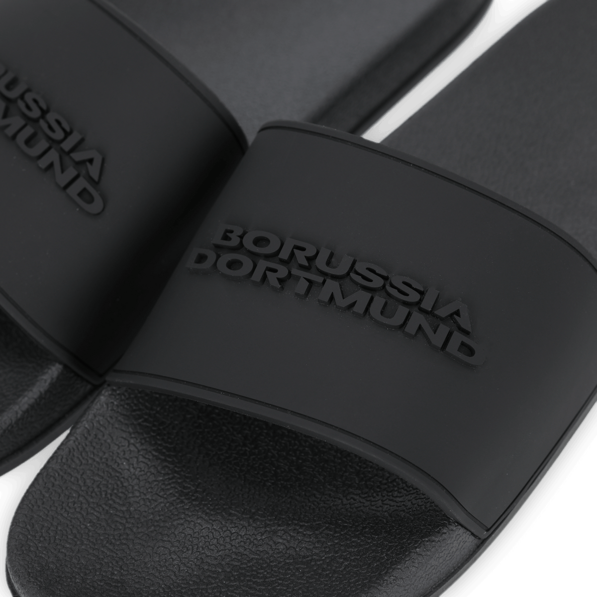 Black BVB bath slippers with embossed "Borussia Dortmund" lettering on the wide strap—a stylish design for fans.