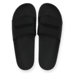 Black BVB bath slippers with embossed "Borussia Dortmund" lettering on the strap, shown from above.