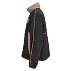 Black BVB track jacket from the Rote Erde collection with yellow piping and beige panels; side view showing the BVB emblem on the chest.