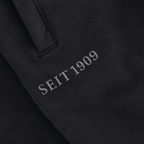 Schwarze BVB Sweatpants für Frauen mit dem Schriftzug 'SEIT 1909', perfekt für Fans von Borussia Dortmund, geeignet für Sport- und Freizeitaktivitäten.