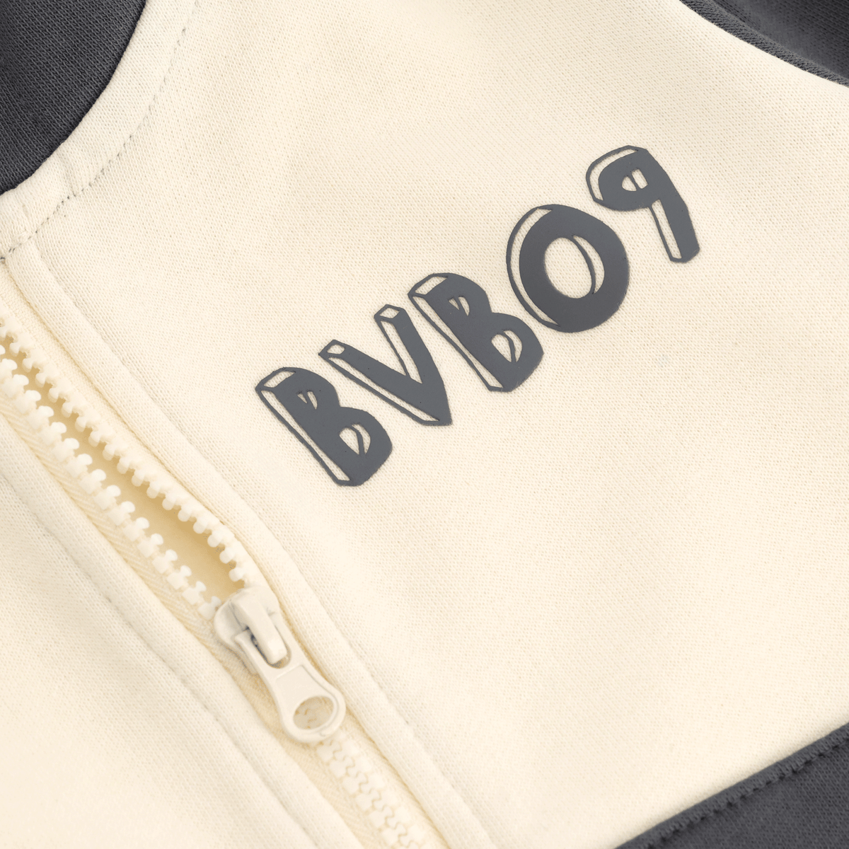 Close-up of a BVB Colorblock II sweatshirt for kids featuring a black-and-yellow design and the BVB 09 logo.