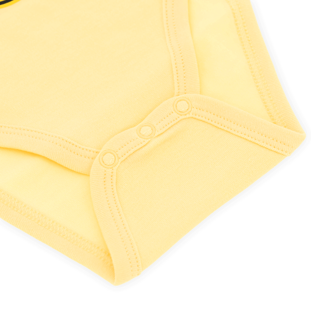 Close-up of a yellow BVB baby bodysuit from the Sesame Street collection with practical snaps.