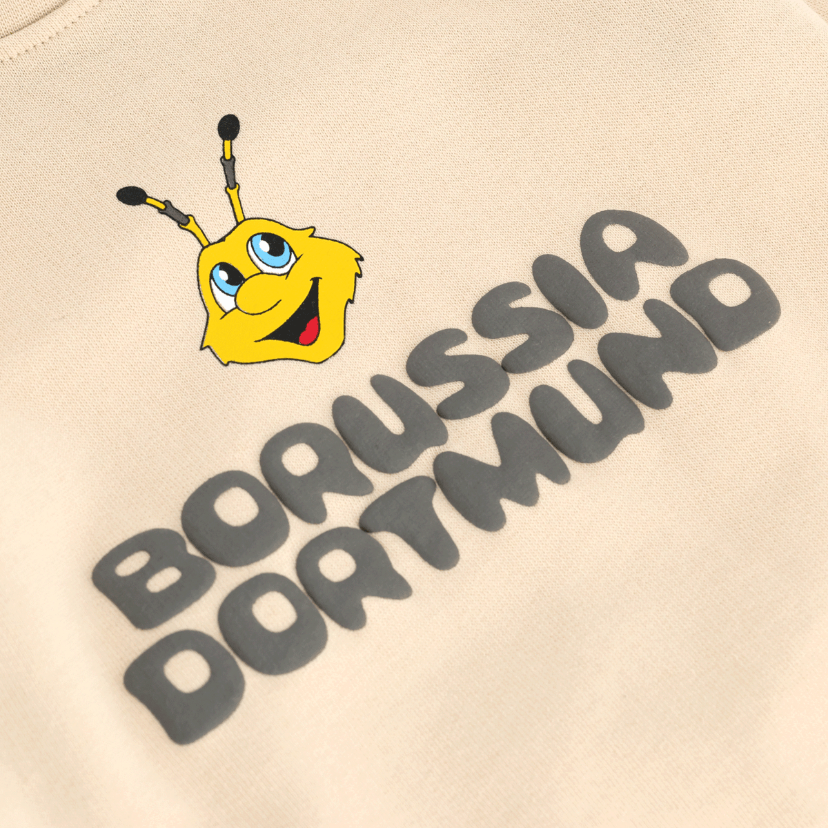 Beige BVB sweater for babies and toddlers featuring the yellow EMMA design and black Borussia Dortmund lettering on the front.