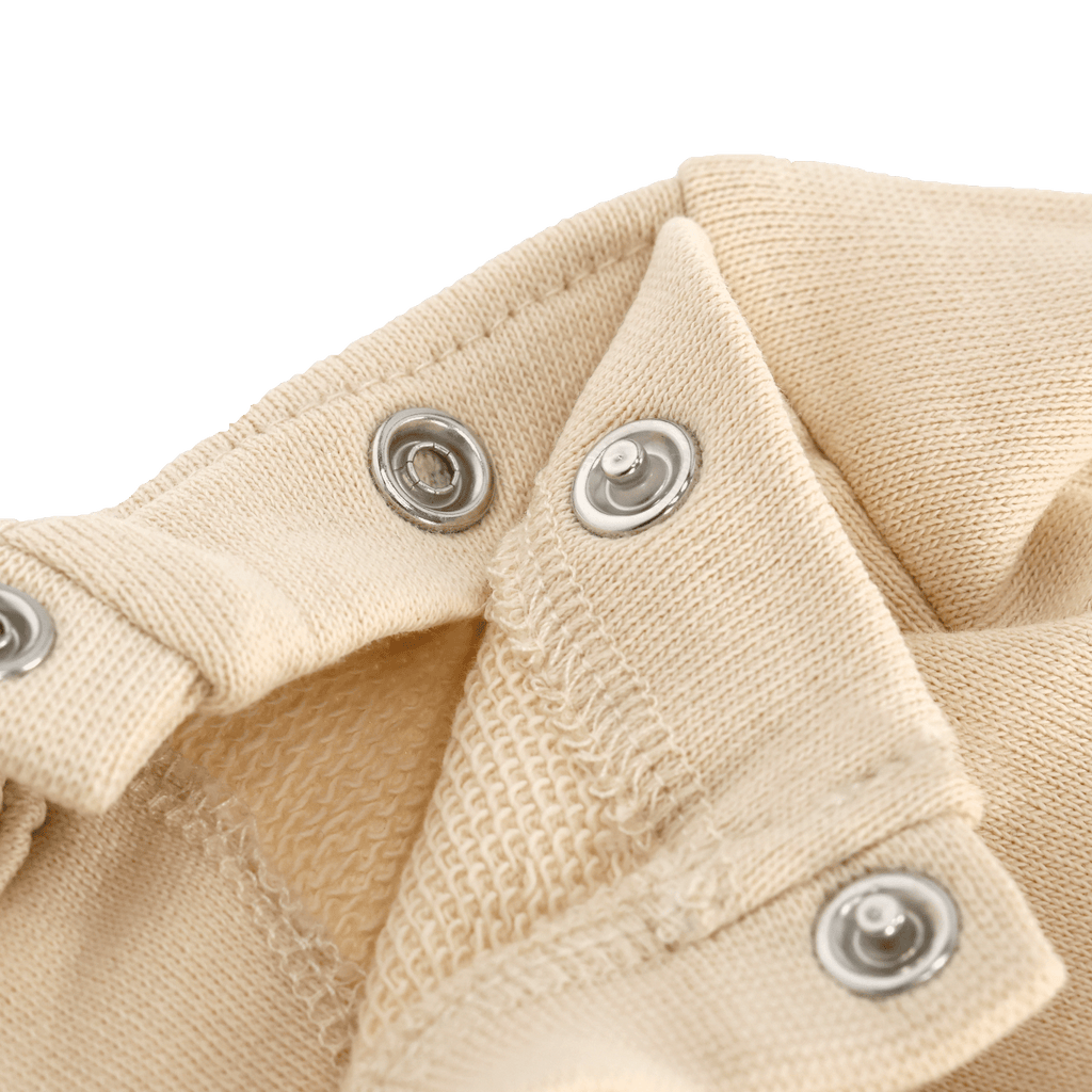 Close-up of a beige BVB sweater for babies and toddlers with snaps.
