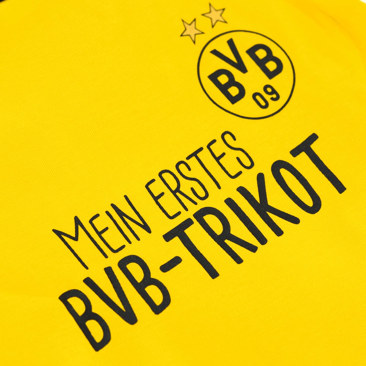 Yellow baby jersey from the BVB gift box featuring black lettering that reads “My First BVB Jersey” and the BVB logo with two stars—perfect for little Borussia Dortmund fans.