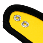 Black-and-yellow baby gift box with silver-colored metal eyelets and a black fabric trim, close-up.