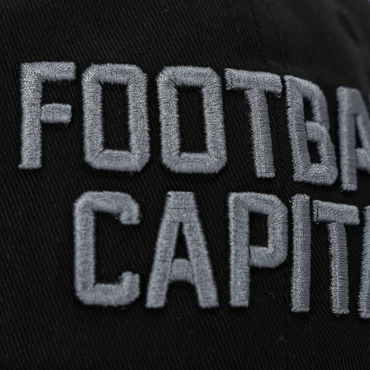 Close-up of a black BVB New Era 9Twenty College children's cap with eye-catching white "FOOTBALL CAPITAL" lettering.