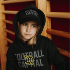 Black BVB New Era 9Twenty College cap for kids, worn by a child, perfect for young Borussia Dortmund fans.