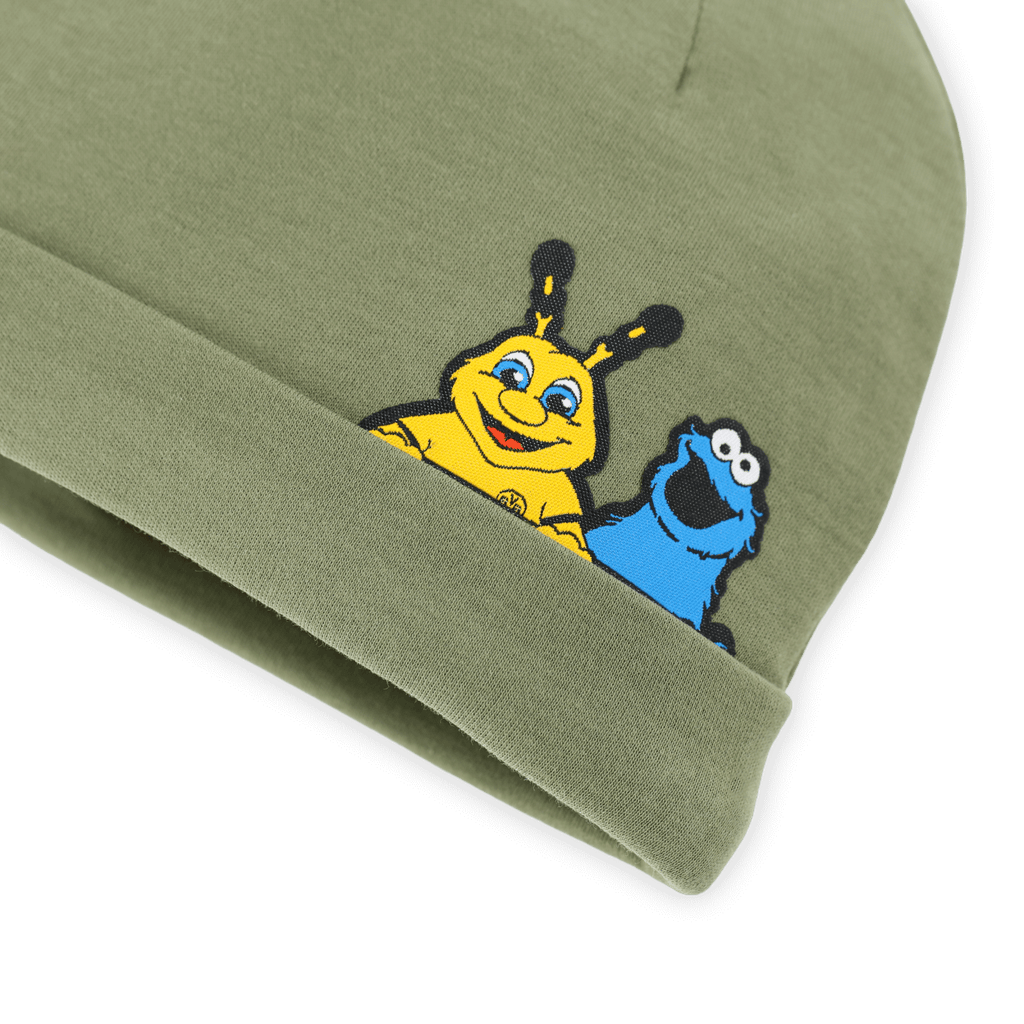 Green baby hat featuring EMMA, the yellow BVB mascot, and the Cookie Monster from Sesame Street; the perfect Borussia Dortmund fan item for kids.
