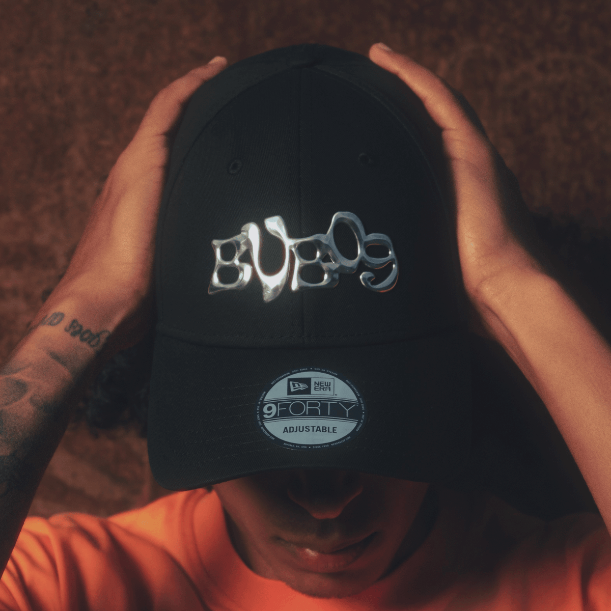 Eine schwarze BVB-Cap New Era 9Forty mit glänzendem silbernem BVB09-Logo und verstellbarem Verschluss, ideal für Borussia Dortmund Fans.