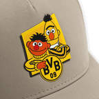 Beige baseball cap for men featuring a Bert and Ernie print from Sesame Street and an integrated BVB 09 logo.