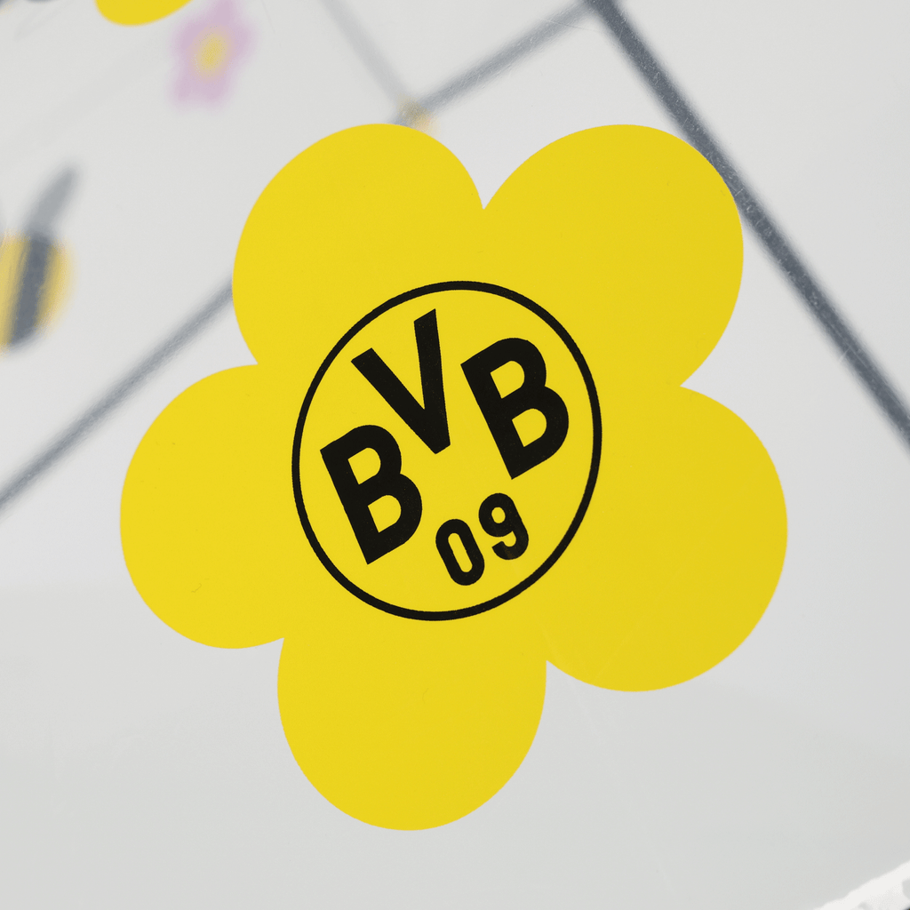 Paraguas infantil del BVB con el logotipo amarillo del BVB con diseño floral sobre una superficie transparente, ideal para los jóvenes aficionados del Borussia Dortmund.