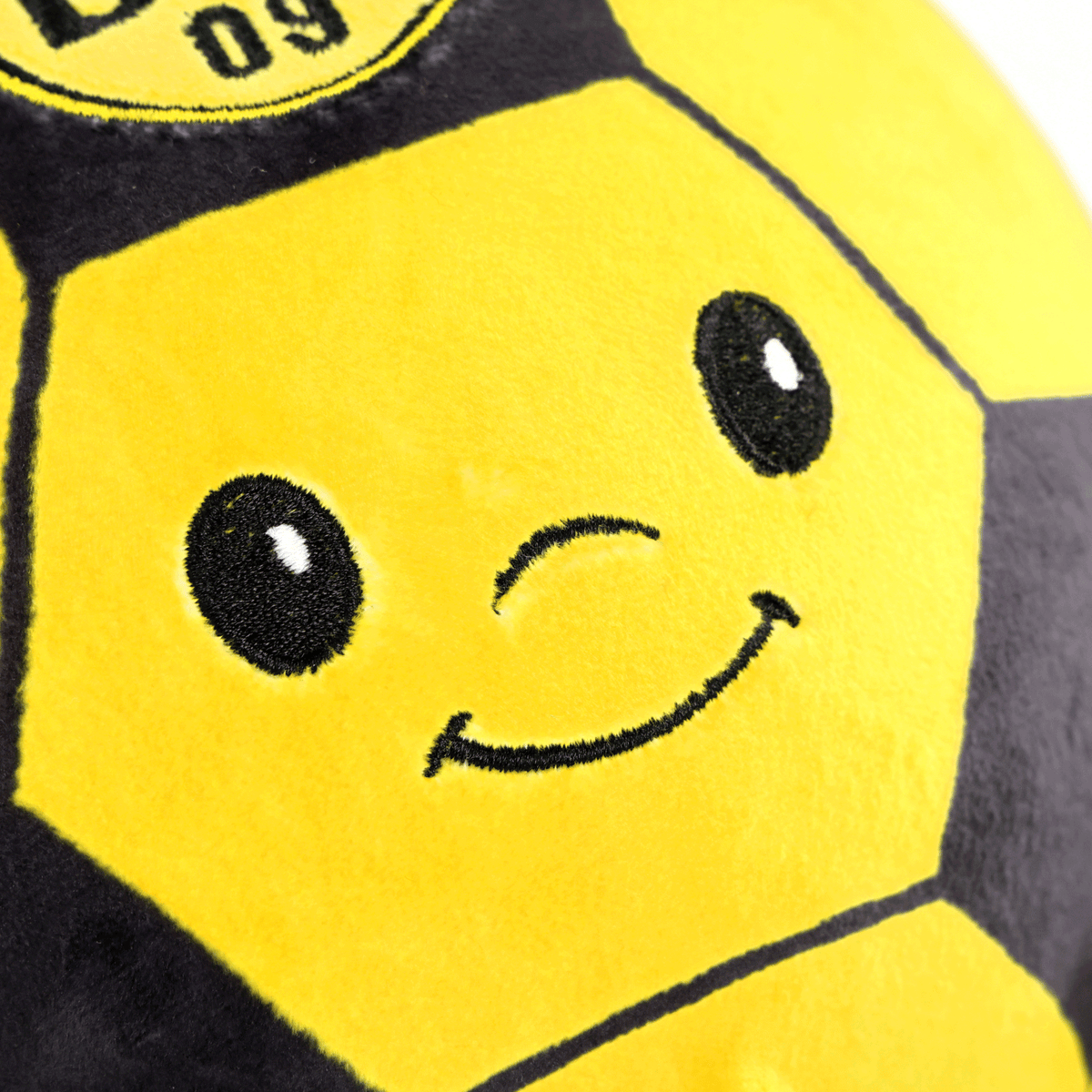 Pallina antistress Squeezy del BVB in peluche nero e giallo, con faccina ricamata e stemma del BVB, ideale come gadget per i tifosi o come pallina antistress.