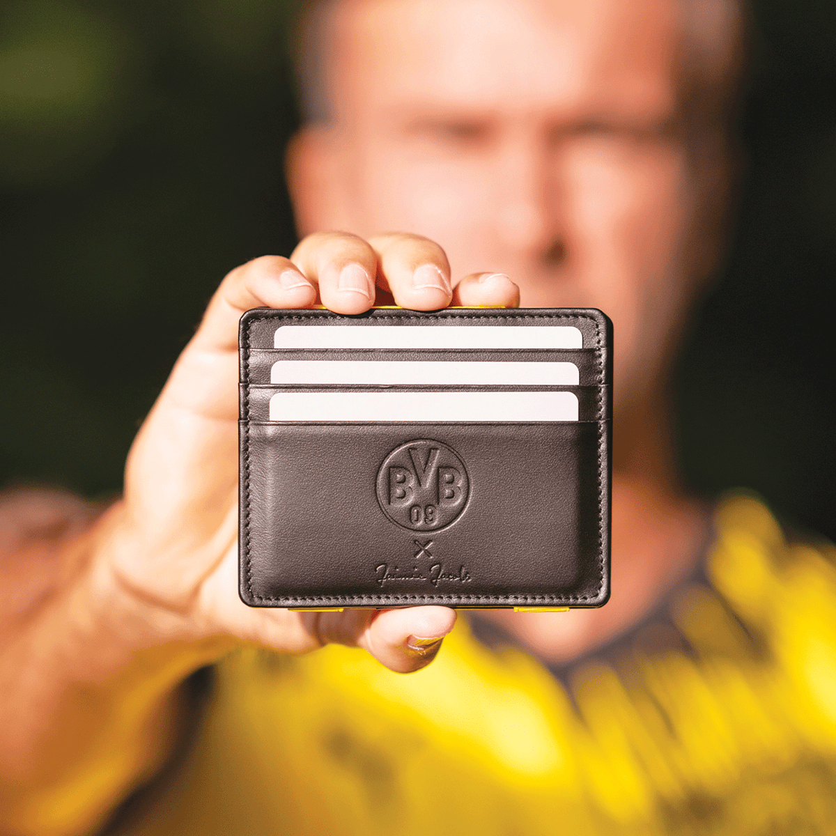 Black BVB card case made of high-quality leather with an embossed BVB logo and a design by Jaimie Jacobs, ideal for Borussia Dortmund fans.