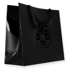 Sac cadeau noir du BVB, avec une finition brillante, de taille moyenne et arborant un grand logo du BVB sur le devant.