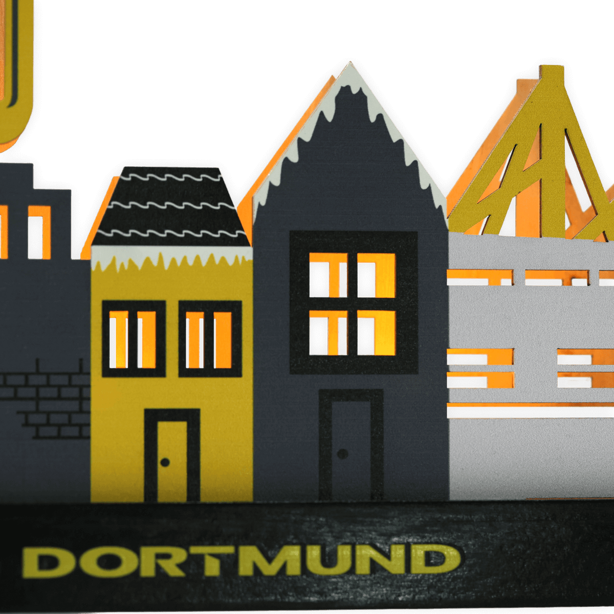 A BVB Christmas village featuring illuminated houses in black-and-yellow colors and "Dortmund" lettering as decorative fan merchandise.