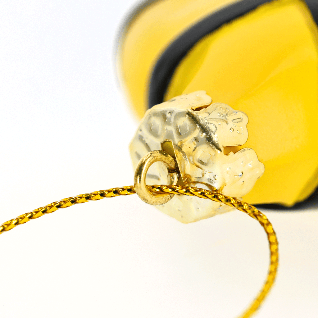 Black-and-yellow BVB tree ornament shaped like a jersey with a gold hanger, ideal for Christmas trees and as a decoration for Borussia Dortmund fans.