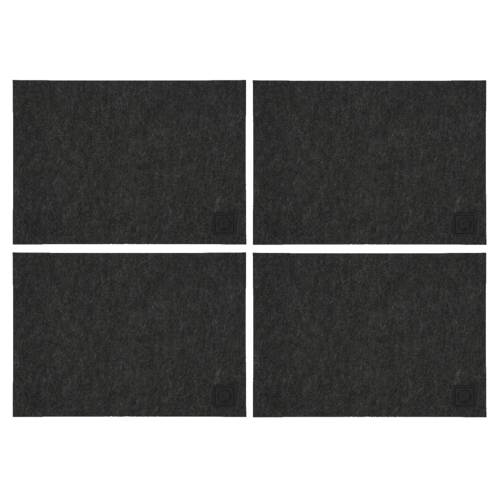 Four black BVB placemats featuring a simple Borussia Dortmund logo—perfect as fan merchandise for the dining table.