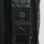 Sac à dos noir et jaune du BVB sur le thème de « Sesame Street », avec le logo PUMA et l'emblème du BVB, idéal pour les enfants et les supporters du Borussia Dortmund.