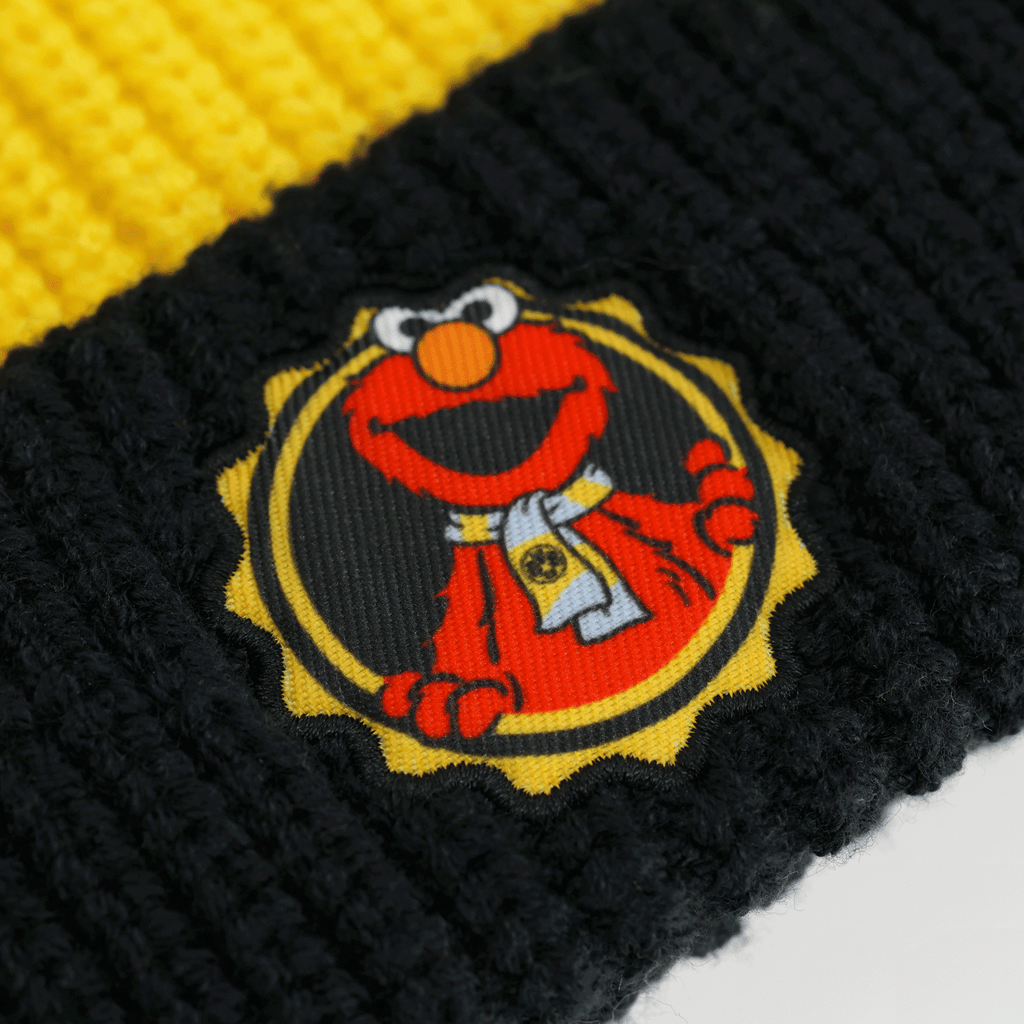 Black-and-yellow BVB children's beanie from the Sesame Street collection featuring the Elmo logo, perfect as a stylish accessory for young fans.